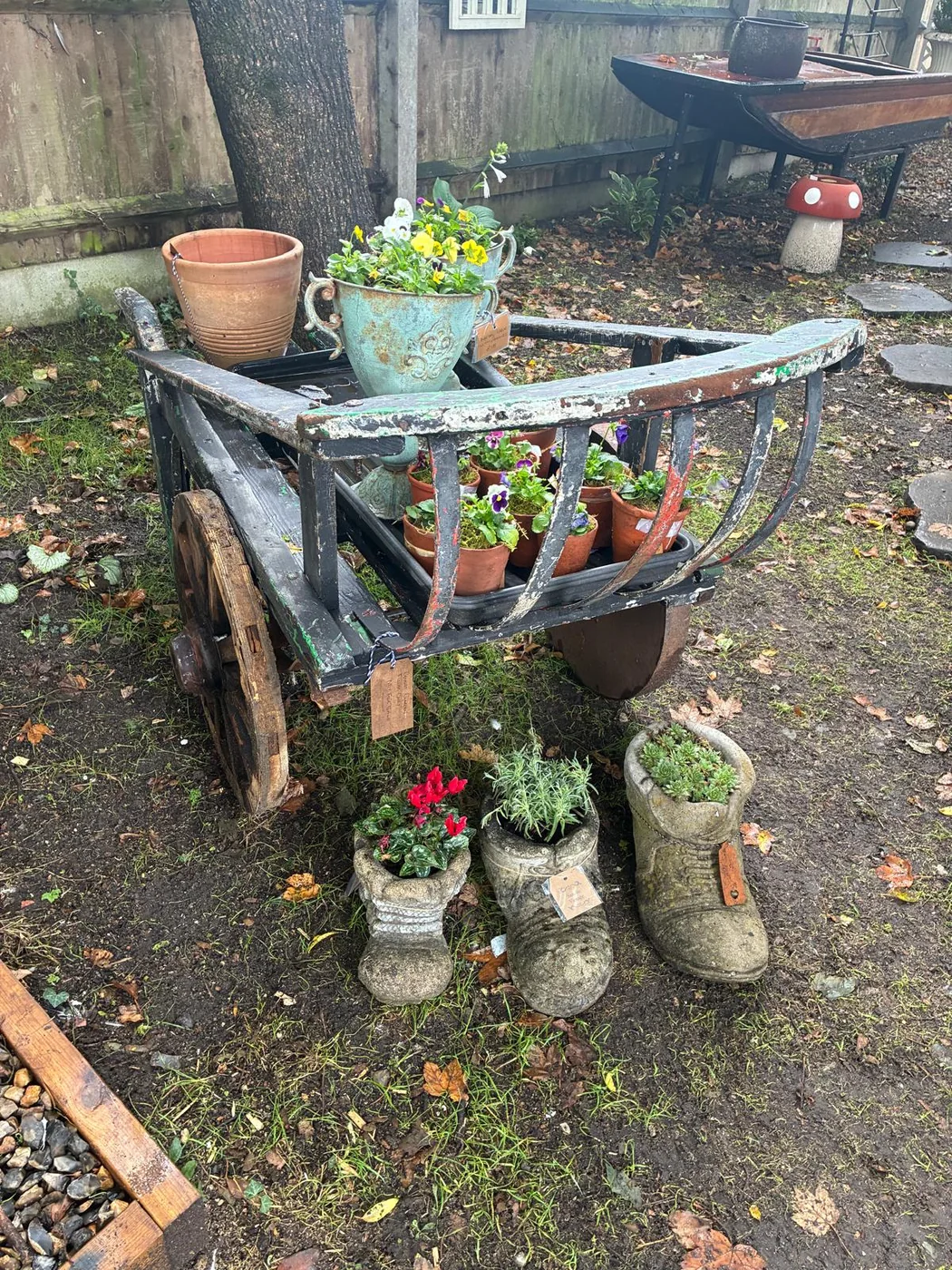 Weathered vintage cart filled with plants and garden pieces