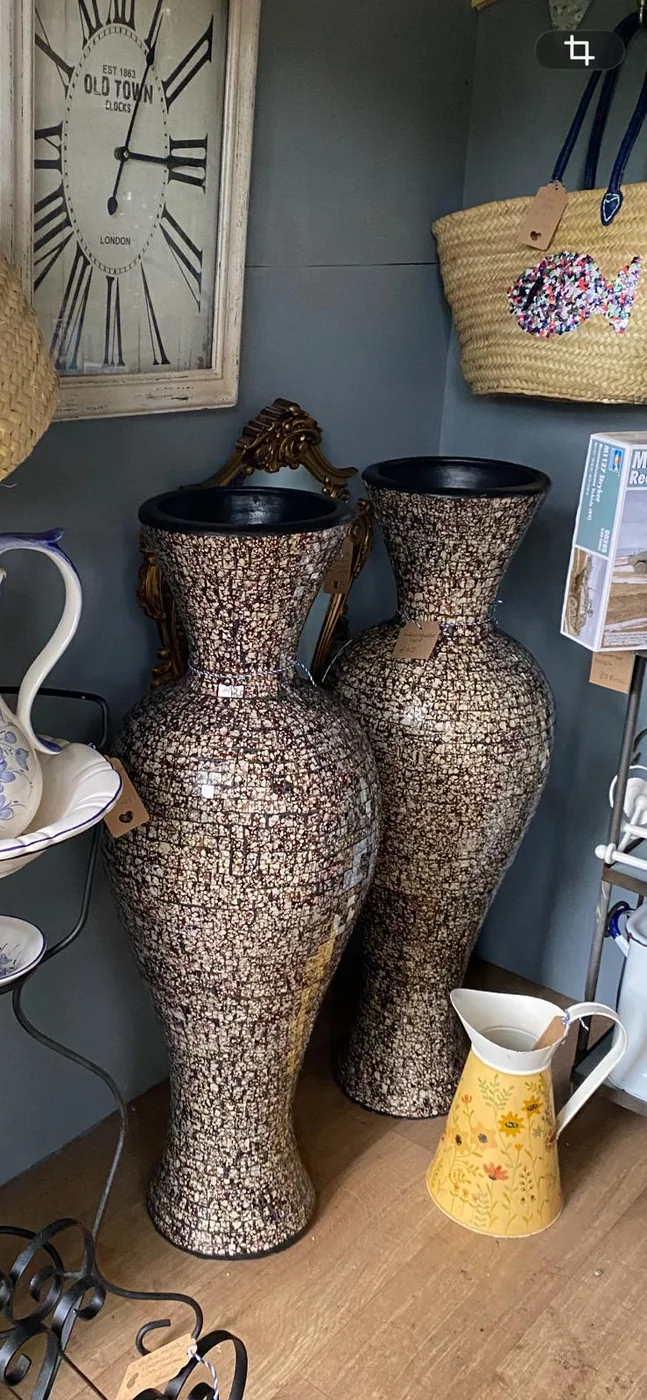 Two tall mosaic-effect vintage floor vases on display